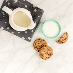 Chocolate chips cookies with milk glass and jar