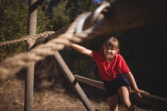 happy girl exercising on outdoor equipment