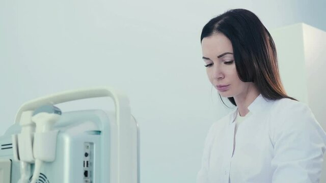 Woman with an ultrasound diagnostic tool