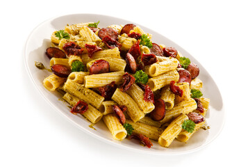 Pasta with sausages on white background