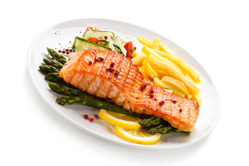 Grilled salmon, French fries and vegetables