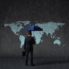 Businessman with umbrella standing over world map background. Business, crisis, failure, concept.