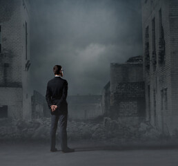 Businessman standing over apocalyptic background. Crisis, default, setback concept.
