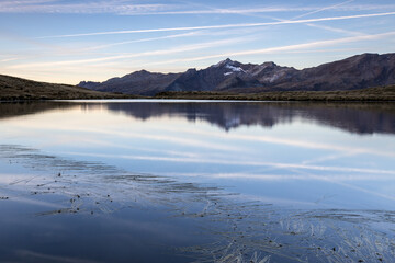 Peaks TambÃ² and Piani are reflected in Lake Andossi at sunrise Chiavenna Valley Valtellina Lombardy Italy Europe