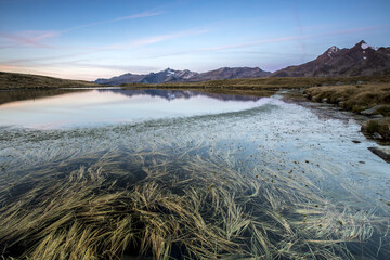 Peaks Tamb&Atilde;&sup2; and Piani are reflected in Lake Andossi at sunrise Chiavenna Valley Valtellina Lombardy Italy Europe