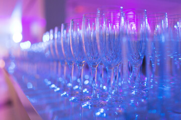 Row of clean glasses for champagne prepared by the barman for drinks. 