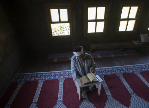 A Man reading al-Quran
