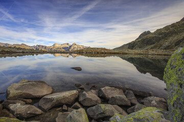 Peaks are reflected in Lake Bergsee at dawn Chiavenna Valley Spluga Valley Switzerland Europe