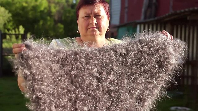 Woman in grey knitted wool shaw smiling. Russia, Urupinsk, national dress.