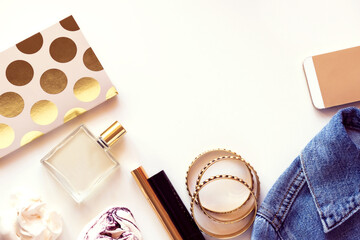 Woman fashion and beauty blogger products from above on white.