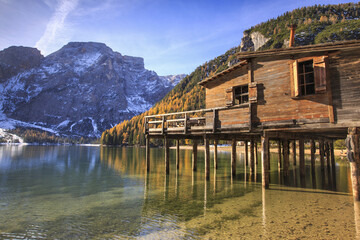 Fototapeta na wymiar Wooden hut in the autumn landscape of Lake Braies Natural Park of Fanes Sennes Bolzano Trentino Alto Adige Italy Europe