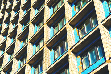 Residential cells of the hostel building. Facade of the building with many windows. Perspective view down. Architectural background