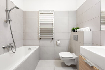 Fototapeta na wymiar Beige bathroom with bathtub