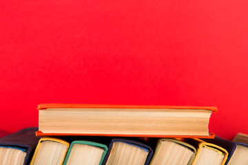 education and wisdom concept - open book on wooden table, color background