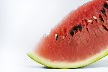 Beautifully cut watermelon slice. Watermelon on white background. Beautiful ripe watermelon close-up.