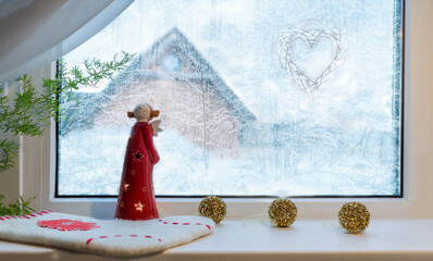 Fototapeta na wymiar Christmas background, angel on winter window.