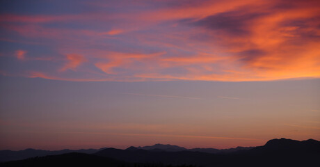 Fototapeta na wymiar Sunset. Sky clouds background. Ridge Mountains silhouette. Skyline. Montenegro