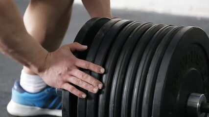 Professional sportsman preparing for training with a barbell