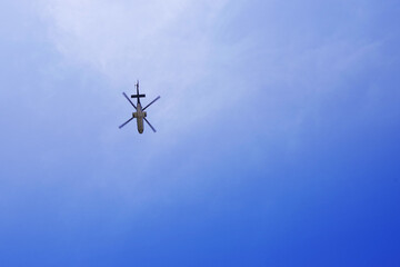 Flying helicopter in the blue sky