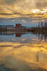 Fototapeta premium evening city at the water's edge at sunset