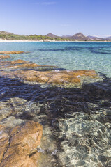 Rocks frame the turquoise water of sea around the sandy beach of Sant Elmo Castiadas Costa Rei Cagliari Sardinia Italy Europe