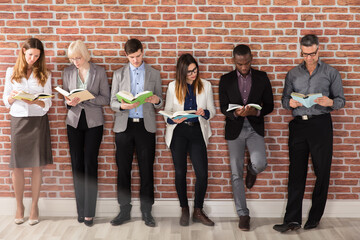 Group Of Businesspeople Reading Books