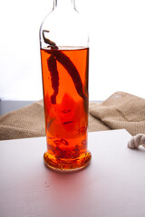 A bottle of vodka and red chili peppers
