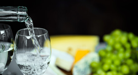 Pouring white wine into the glass