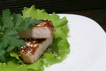 Beef steak on lettuce leaves.