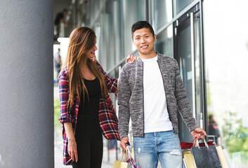 happy interracial couple - boyfriend and girlfriend shopping