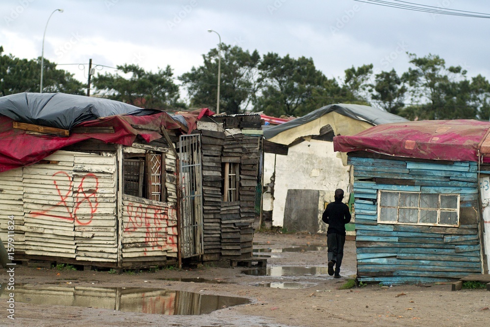 Wall mural Houses and slums in the township of Langa in Cape Town reflecting in the puddles left behind by a heavy storm - South Africa