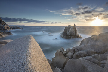 Sunset on modeled cliffs by wind framing blue sea Capo Testa Santa Teresa di Gallura Province of Sassari Sardinia Italy Europe