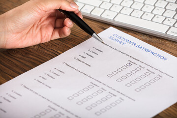 Businesswoman Filling The Customer Satisfaction Survey Form