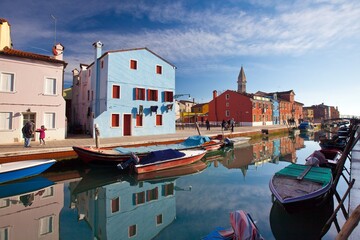 Fototapeta na wymiar Boats resting along one of the many channels of the Burano island, the most visited island on the Venetian Lagoon, Venice Veneto Italy Europe