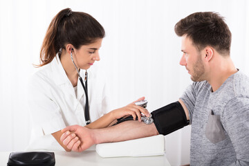 Female Doctor Measures Her Blood Pressure
