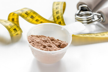 protein powder for fitness nutrition to start training and measure tape white background