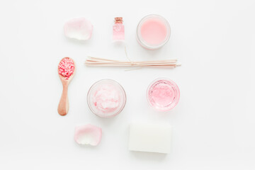 homemade spa with rose cosmetic set, cream, salt and oil on white background top view