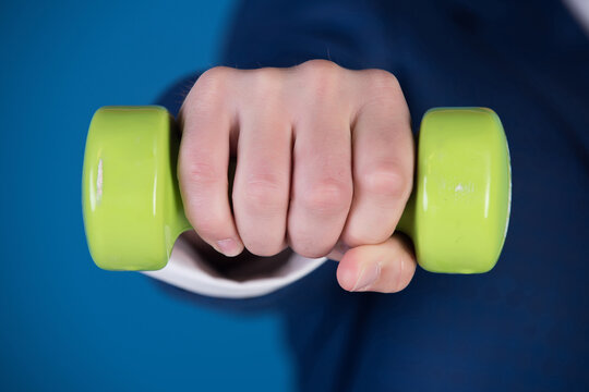 Hand With Green Barbell Of Man On Blue Background