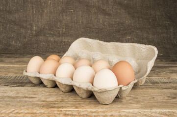 Eggs in a tray on a wooden background