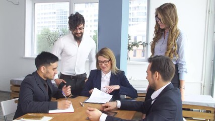Conclusion of the transaction and signing of the cooperation agreement. Successful business man at a meeting in the office. Colleagues are sitting at the negotiating table