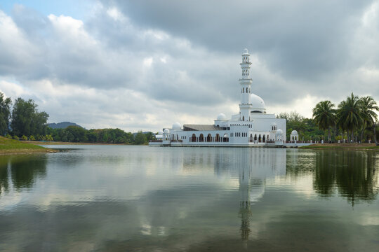 Tengku Tengah Zaharah floating mosque and lake reflection located at Kuala Terengganu, Malaysia over sunset background.