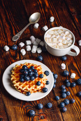 Waffles with Blueberry and Hot Chocolate.