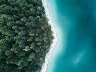 Aerial Drone photo of lake Eibsee with forest in Germany