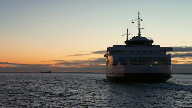 Ferry boat departing from Helsingborg, Sweden harbor at dusk