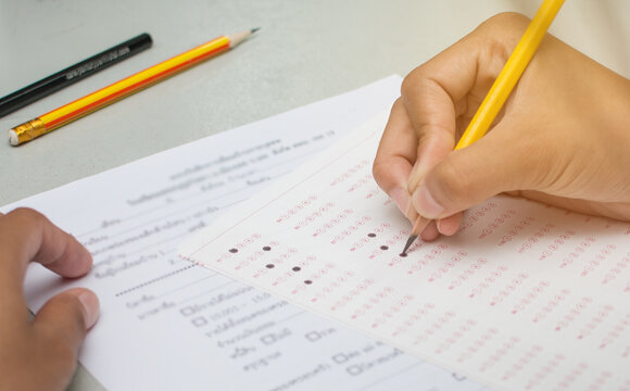blurred of Asian, Thai student testing in exercise, or taking exams answer sheets in school class room