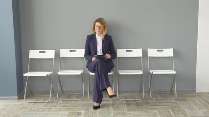 Confident business woman holding in hands tablet computer. Attractive woman in business clothes at the office. Portrait of businessmen