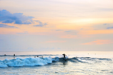 Surfing on Bali at sunset