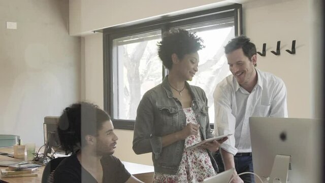 Colleagues chatting in office