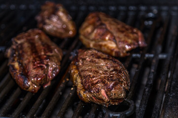 Picanha cow steak beef barbecue on a iron grill with soft focus on the background