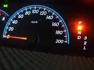 The illuminated speed gauge on dashboard represent the automotive part and technology concept related idea.